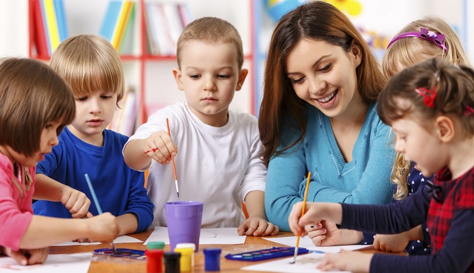 Group Of Elementary Age Children In Art Class With Teacher